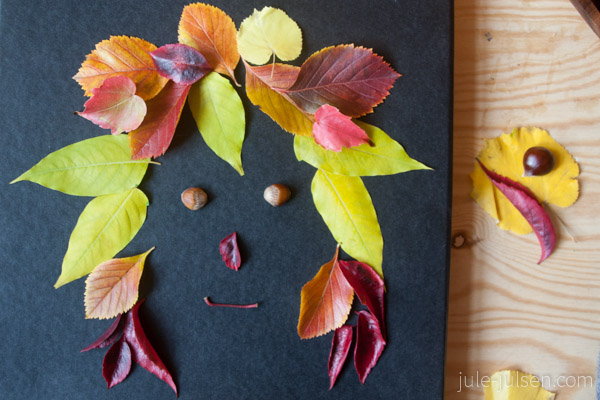 Gesicht aus bunten Herbstblättern auf schwarzem Hintergrund Gesicht aus bunten Herbstblättern auf schwarzem Hintergrund